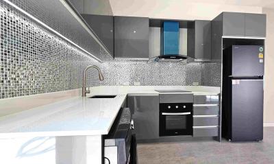 Modern kitchen with stainless steel appliances and mosaic backsplash