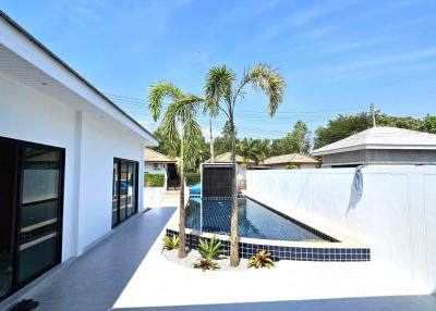 Modern home exterior with swimming pool and garden area