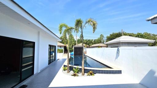 Modern home exterior with swimming pool and garden area