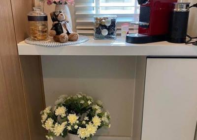 Cozy kitchen corner with coffee machine and decorative flowers