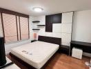 Modern bedroom with large bed and built-in wardrobes