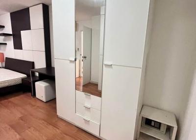 Modern bedroom with large mirrored wardrobe and parquet flooring