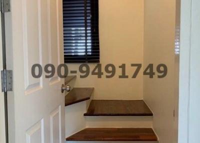 Interior staircase with wooden steps and white door