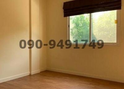 Empty bedroom with laminate flooring and air conditioning unit