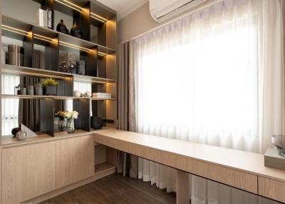Elegant contemporary living room interior with custom shelving and sheer curtains