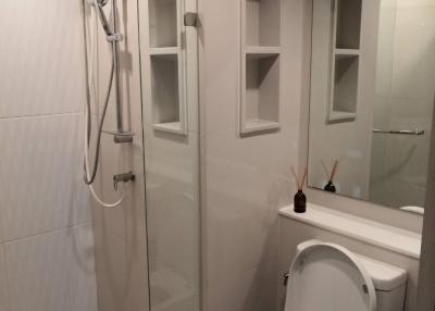 Modern bathroom with a glass shower enclosure and white ceramic fixtures