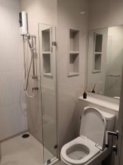 Modern bathroom with a glass shower enclosure and white ceramic fixtures