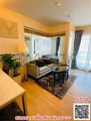 Cozy and well-lit living room with modern furniture and balcony access