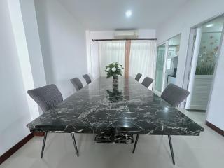 Modern dining room with large marble table and comfortable seating