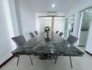 Modern dining room with large marble table and comfortable seating