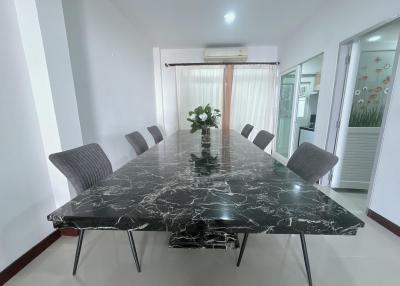 Modern dining room with large marble table and comfortable seating