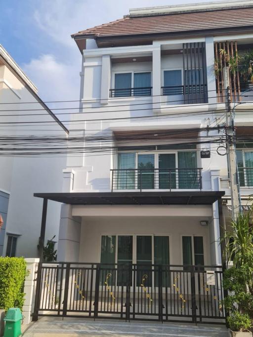 Modern two-story house with a covered patio and balcony