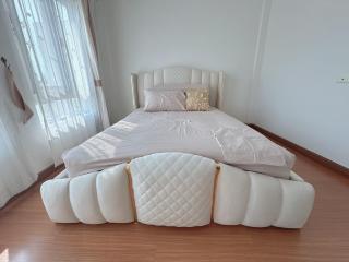 Spacious bedroom with large bed and wooden floor