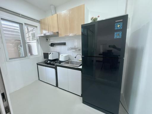 Modern kitchen with stainless steel appliances and wooden cabinets