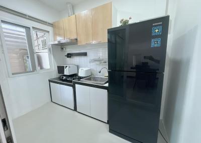 Modern kitchen with stainless steel appliances and wooden cabinets