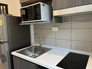 Modern kitchen with stainless steel appliances and gray cabinetry