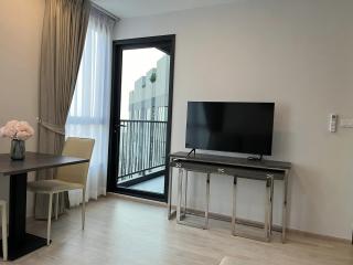 Modern living room with television and balcony access