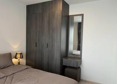 Modern bedroom with a large wardrobe and bedside lamp