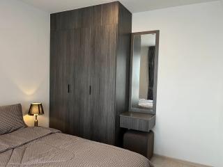 Modern bedroom with a large wardrobe and bedside lamp