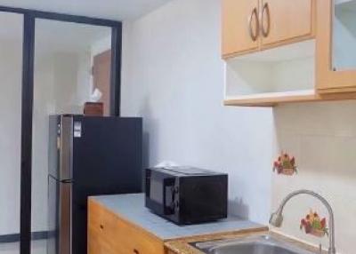 Compact modern kitchen with wooden cabinets and stainless steel sink