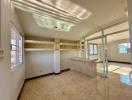 Spacious and well-lit living area with tiled flooring and large windows