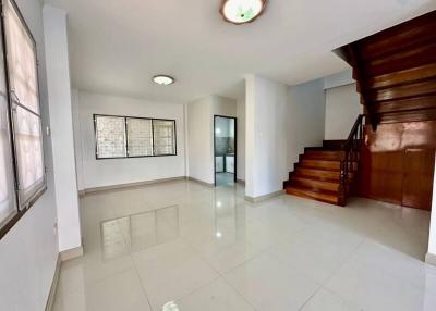 Spacious living area with staircase and abundant natural light