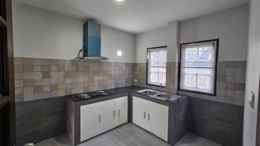 Modern kitchen with stainless steel appliances and tiled backsplash