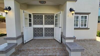 Elegant front entrance of a residential property with decorative door and brick paving