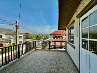 Spacious balcony with a view of the neighborhood and clear skies