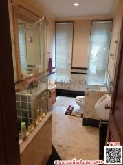 Spacious bathroom with full bathtub, toilet, and bidet