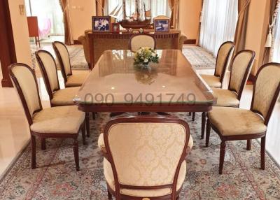 Elegant dining room with a large wooden table and upholstered chairs