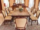 Elegant dining room with a large wooden table and upholstered chairs