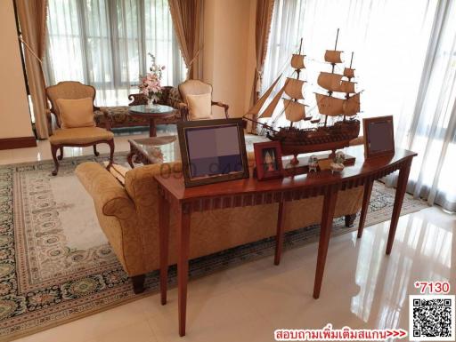 Elegant living room with traditional furniture and decorative sailing ship model