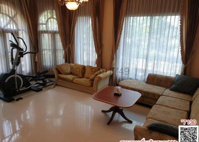 Spacious living room with exercise equipment and ample natural light