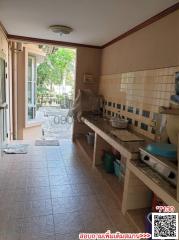 Spacious kitchen with tiled countertops and ample natural light