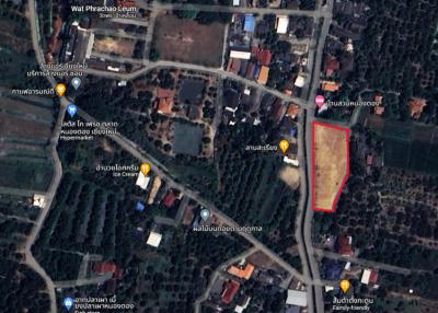 Aerial view of property land for sale surrounded by trees and nearby structures