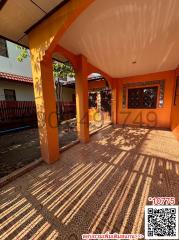 Sunlit patio with terracotta tiles and arched columns