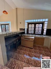 Compact kitchen with tiled flooring and natural light