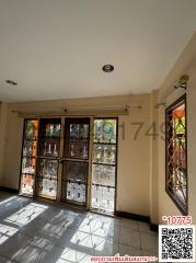 Spacious living room with natural lighting through French windows