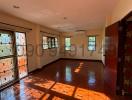 Spacious living room with hardwood floors and ample natural light