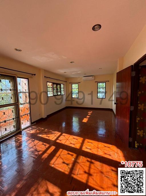 Spacious living room with hardwood floors and ample natural light