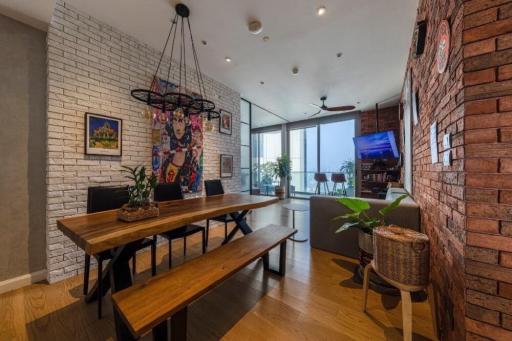 Spacious dining area with modern brick wall design and large windows