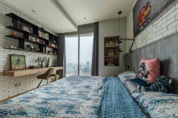 Modern bedroom with brick wall and large window with city view