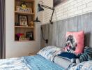 Cozy bedroom with stylish bedding and an exposed brick wall