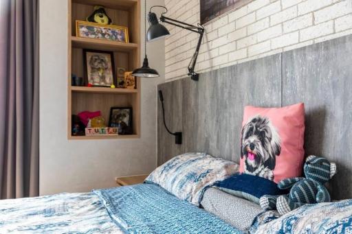 Cozy bedroom with stylish bedding and an exposed brick wall