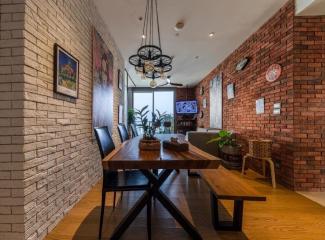 Stylish dining room with brick walls and modern furniture