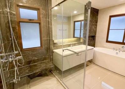 Modern bathroom with glass shower enclosure and marble finishes