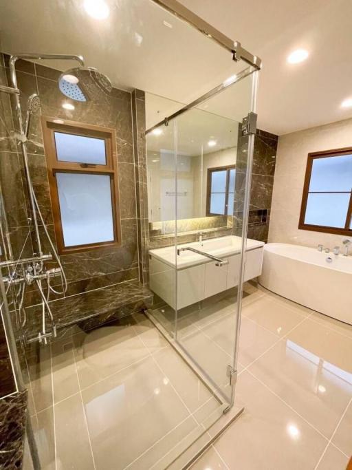 Modern bathroom with glass shower enclosure and marble finishes