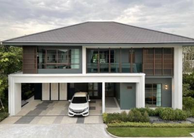 Modern two-story house with a white car parked in the driveway