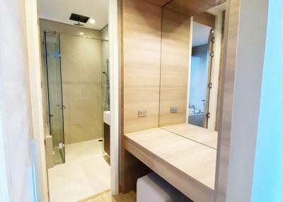 Modern bathroom with glass shower and wooden vanity